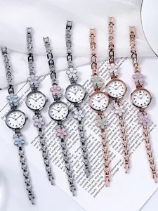 Detail view of floral bracelet watches with enamel petals and sparkling crystal accents