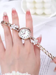 Detailed shot of rose gold women watch with flower bracelet and white enamel accents
