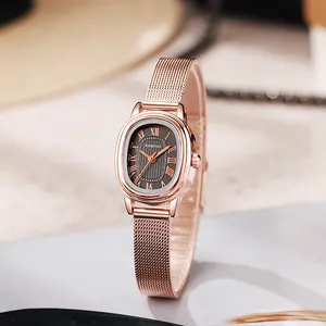 Detail of rose gold oval watch with dark grey sunburst dial and Milanese mesh strap