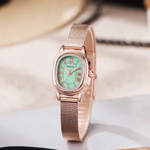 Detail of rose gold oval watch face with mint green dial and Roman numerals