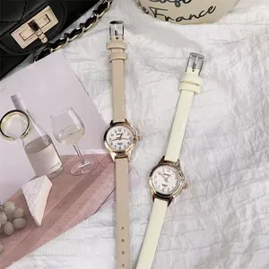 Detail of elegant small dial women watches with slim leather straps in French chic style