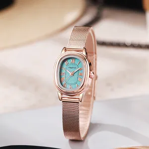 Detailed close-up of rose gold oval watch with green rippled dial and mesh strap