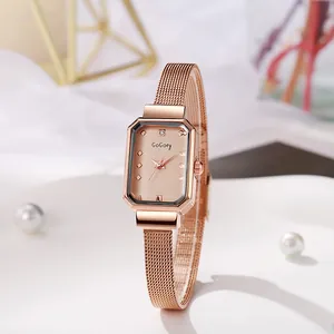 Macro view of rose gold octagonal watch case with minimalist dial and mesh strap