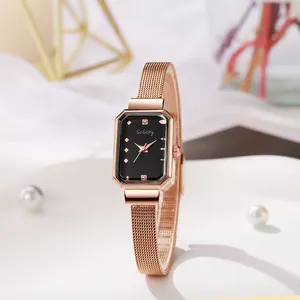 Close-up of rose gold mesh band watch with rectangular black dial and minimalist markers