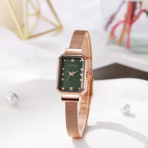 Detail view of rectangular rose gold watch with green dial and mesh strap