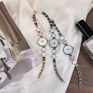 Elegant women's quartz bracelet watch set with enamel star charms on silky background