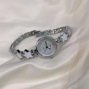 Detail of silver ladies quartz watch with heart pattern dial and star link bracelet