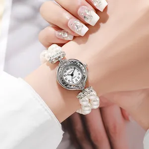 Elegant women's pearl bracelet watch with silver dial and stretch beads on a wrist