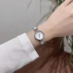 Detail of silver ladies bracelet watch with unique star-shaped links and white dial