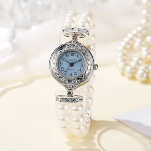 Elegant vintage pearl bracelet watch with blue dial and ornate silver-tone metal bezel