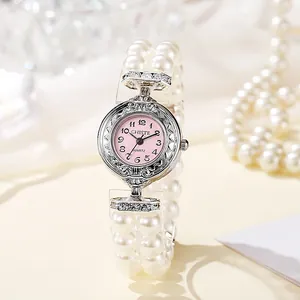 Elegant women's quartz watch featuring pink dial and dual-row pearl elastic bracelet