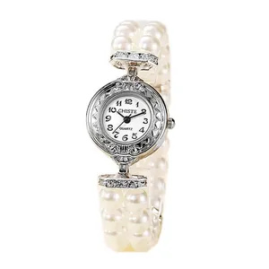 Elegant women's quartz watch featuring a pearl bead bracelet and vintage engraved silver dial