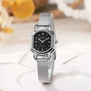 Close-up of elegant silver tonneau quartz watch with black dial and mesh steel strap
