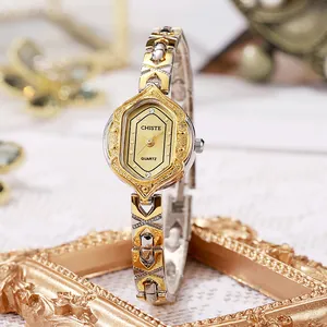 Close-up of hexagonal two-tone quartz watch dial with gold and silver link bracelet