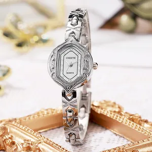 Vintage silver quartz watch for women featuring unique oval case and engraved strap