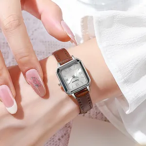 Elegant rectangular women's watch with silver case and brown leather strap on wrist