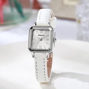 Detail of square vintage ladies watch with silver case and white leather strap