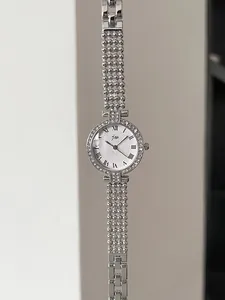 Detailed view of silver crystal-encrusted round watch with elegant bead chain bracelet band