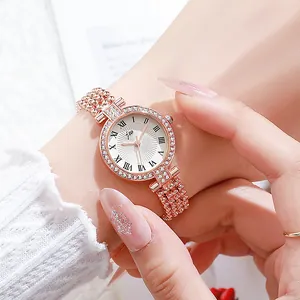 Rose gold women quartz watch with rhinestone bezel and bead bracelet strap on wrist