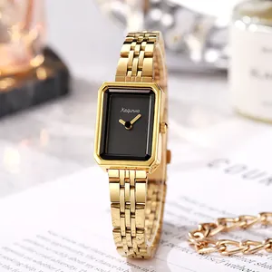 Detail of vintage style gold steel watch with rectangular black dial and metal strap