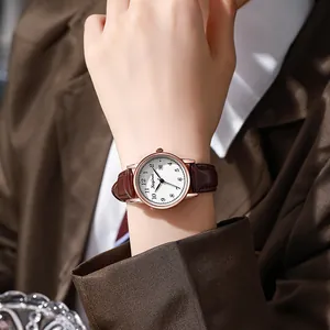 Women's vintage quartz watch with brown leather strap and rose gold calendar dial