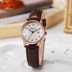 Close-up of retro ladies watch featuring a white dial, date window, and brown leather strap