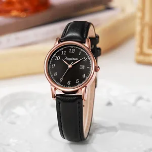 Close-up of rose gold quartz watch with black leather strap and date display feature