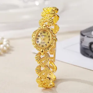 Elegant women's vintage gold quartz watch with a carved chain strap and oval dial