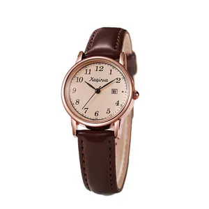 Vintage women's watch with brown leather strap, rose gold case, and date display