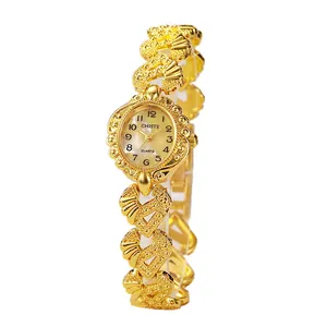 Elegant gold vintage bangle watch for women with oval pearl dial and floral petal strap