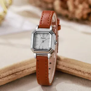 Detail of silver octagonal quartz watch case with brown lychee leather strap texture