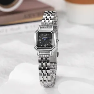 Detailed close-up of a square black dial watch with silver stainless steel link strap