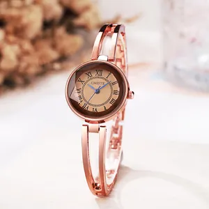 Elegant rose gold women's quartz watch with hollow bracelet and roman numeral dial