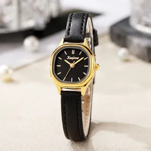 Elegant women's quartz watch with black tonneau dial and gold case on leather strap