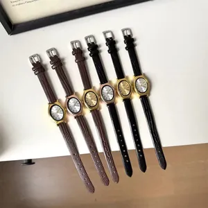 Detail view of retro oval quartz watches with textured leather straps in multiple colors