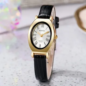 Macro detail of oval gold case watch with Roman numerals and black leather croc strap