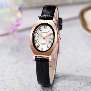 Macro detail of oval rose gold watch case with Roman numerals and black leather strap