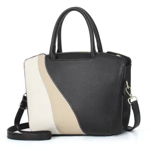 Grote vintage patchwork handtas in zwart en wit met handvatten en schouderriem