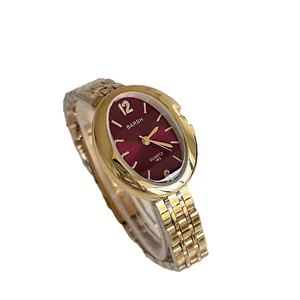 Elegante orologio da donna ovale al quarzo dorato con quadrante rosso e cinturino