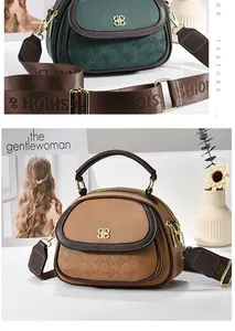 Detail of multi-pocket leather handbag with wide nylon strap and gold logo hardware
