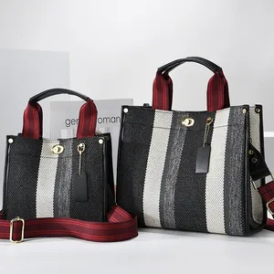Striped woven tote bag in black and white with leather trim and detachable strap