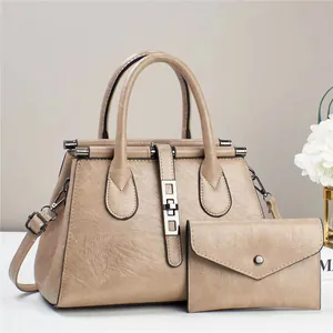 Close-up of khaki PU leather bag set with detailed lychee texture and silver metal hardware