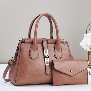 Caramel brown leather tote bag and matching envelope clutch set with silver hardware