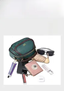 Detail view of spacious green tote bag showing compartments and daily essentials