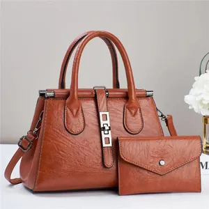 Vintage brown textured leather handbag set with matching envelope flap clutch bag
