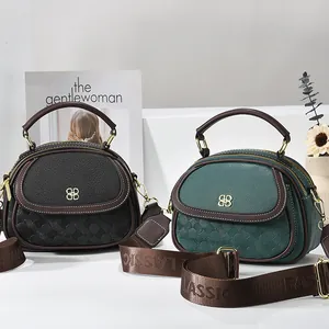 Classic shell-shaped tote bags in black and green with chic wide straps and gold hardware
