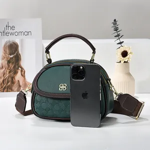 Retro multi-pocket green handbag with textured patterns and wide brown shoulder strap