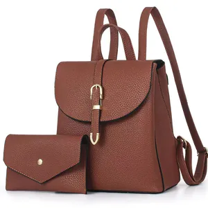Brown leather backpack and matching clutch set with gold buckles on a white background