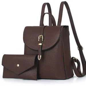 Dark brown pebble leather backpack set with a matching envelope clutch and gold buckle