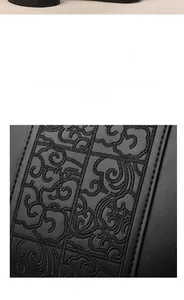 Close-up of elegant cloud pattern embroidery on high-quality black leather handbag fabric